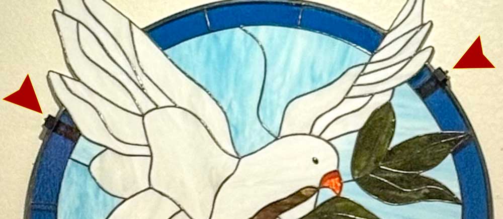 Detail of stained glass mounted on wall with Art Fitters Narrow Adjustable Brackets